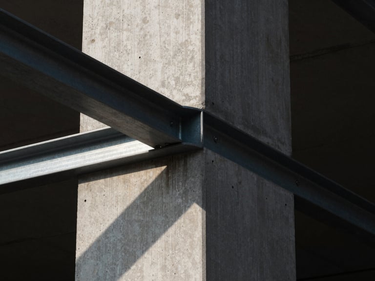 Close-up of a sharp architectural intersection where a raw concrete column meets a flush steel frame, dramatic geometric sunlight casting a clean diagonal shadow.