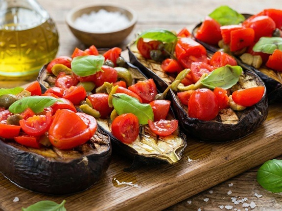 Mediterranean eggplant bruschetta with cherry tomatoes, olives, and capers