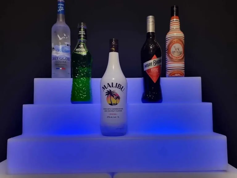 Blue glow drink stand with bottles of alcohol, accessory to glow bar in Gold Coast.