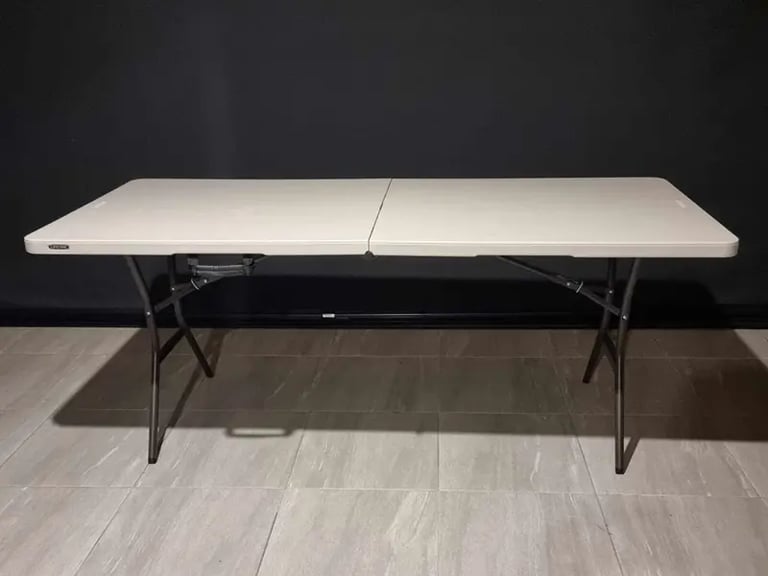 Folding lifetime table with a white spandex cover available for hire in Redlands.