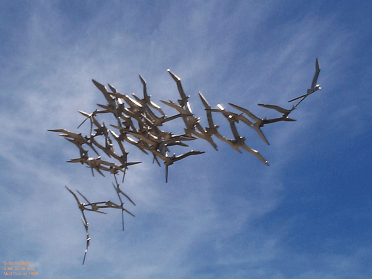 Steel sculpture of a flock of shearwaters in flight