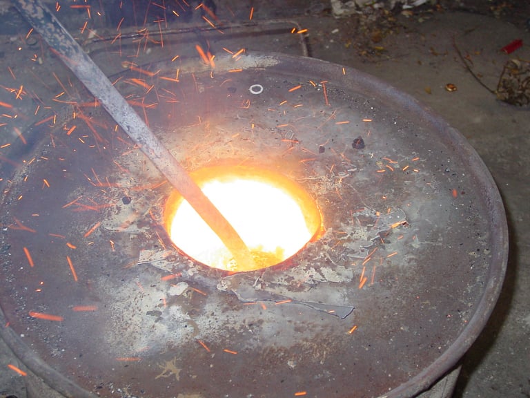 Close up of the bronze in the crucible being stirred