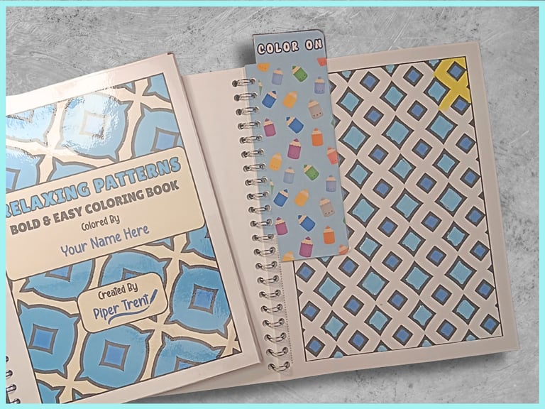 open coloring book with a colored page and a snap in bookmark that says "COLOR ON"