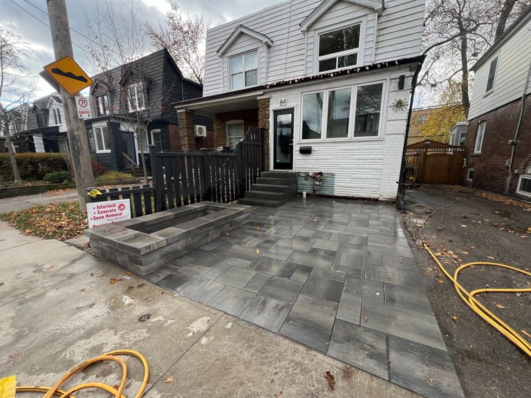 interlock driveway with stone planter and stone steps