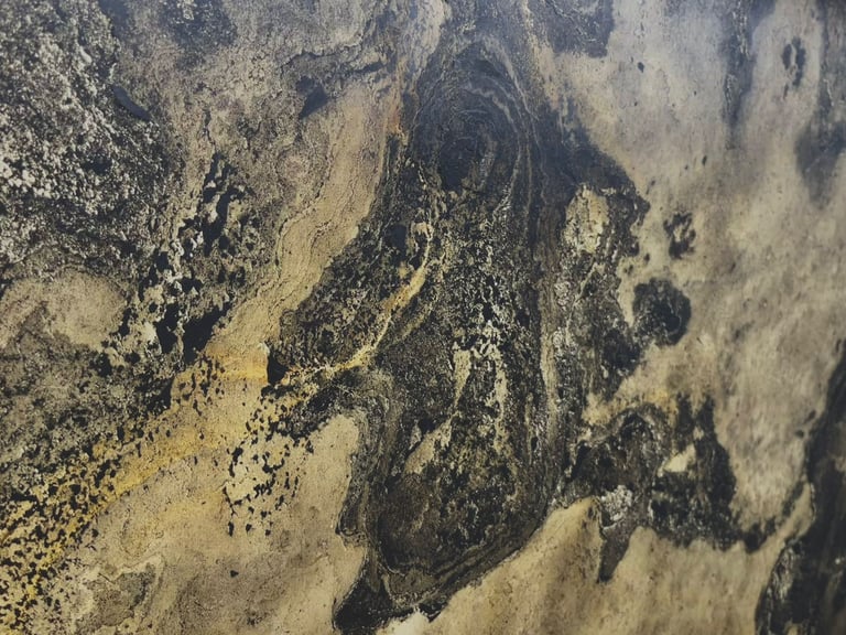 Polished black and gold marble slab with abstract natural stone patterns for luxury interior design.