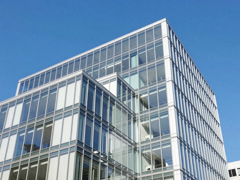 Abstract high-contrast architectural shot of a modern financial center facade, bright blue sky reflecting on clean glass panels