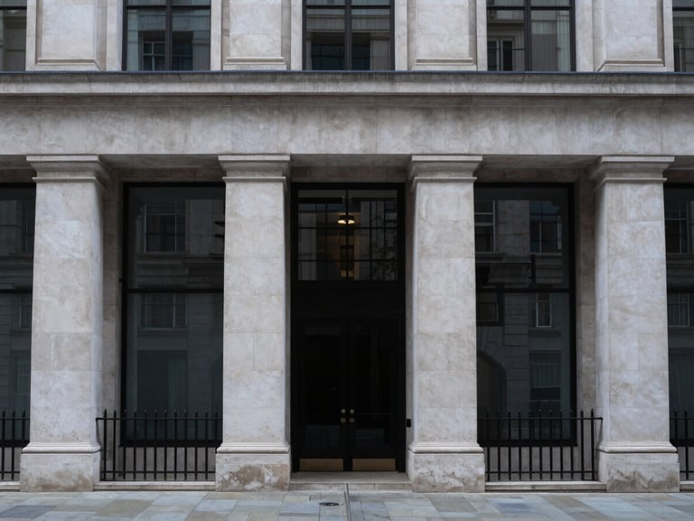 Symmetrical modern limestone facade of a financial institution in London, cool overcast daylight, desaturated slate tones, 35mm