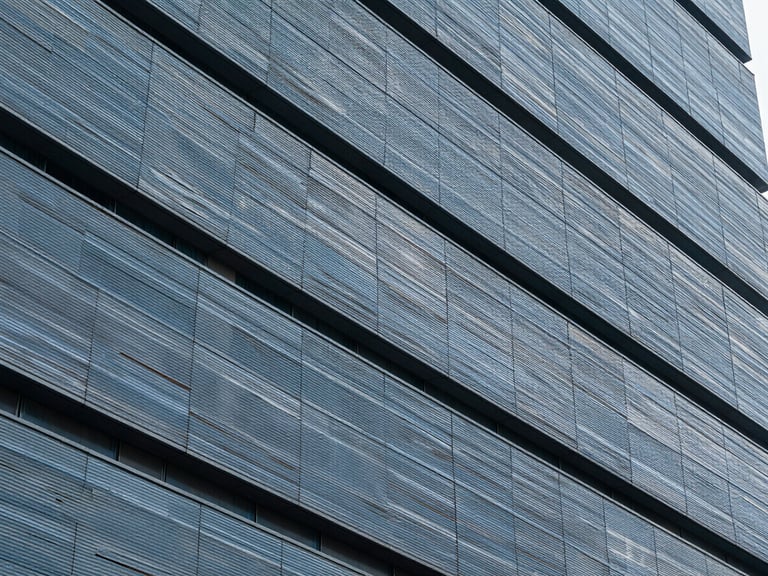 Architectural detail of a modern building facade with intersecting lines, emphasizing structure and resilience, cool diffused daylight.
