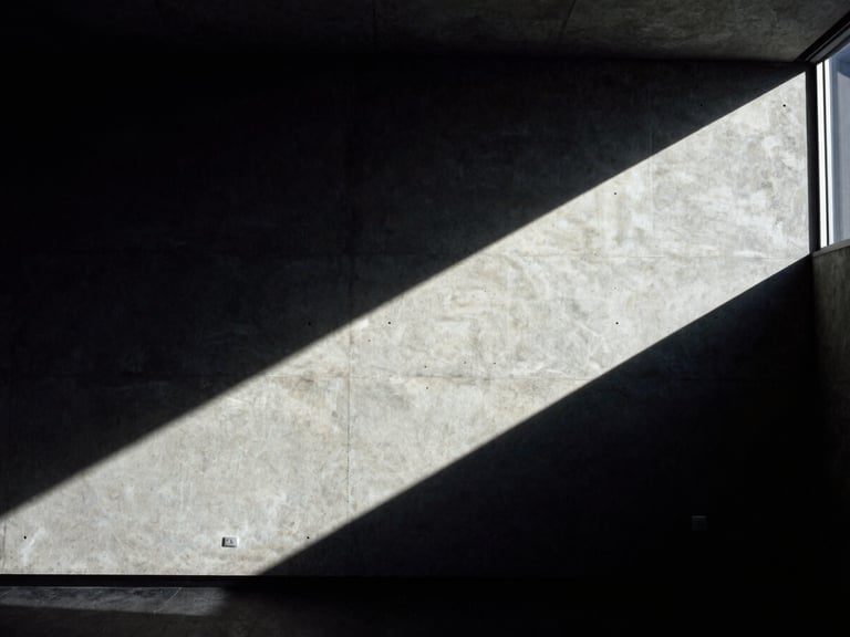 Architectural detail of a modern concrete boardroom corner with sharp geometric shadows and low-key lighting, high-contrast, editorial 35mm film.
