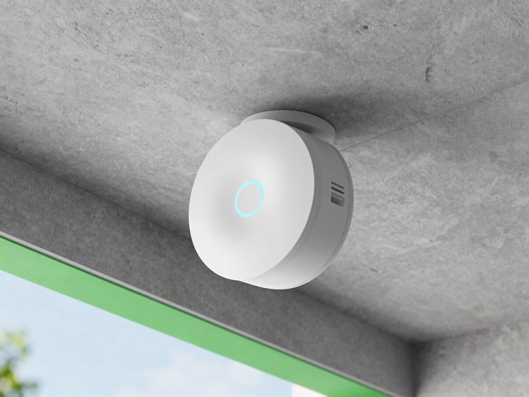 Sleek round white WiFi access point mounted on a raw concrete ceiling, status ring glowing soft blue, clean modern architectural lines