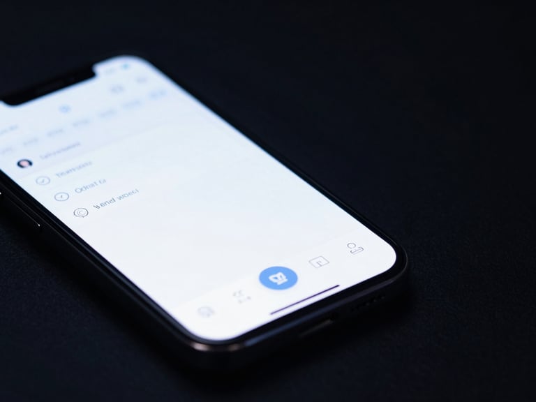 Wide panoramic macro shot of a physical mobile device displaying a clean IDE-inspired mobile app interface, cool low-key studio lighting with subtle blue highlights, generous negative space on the right side.