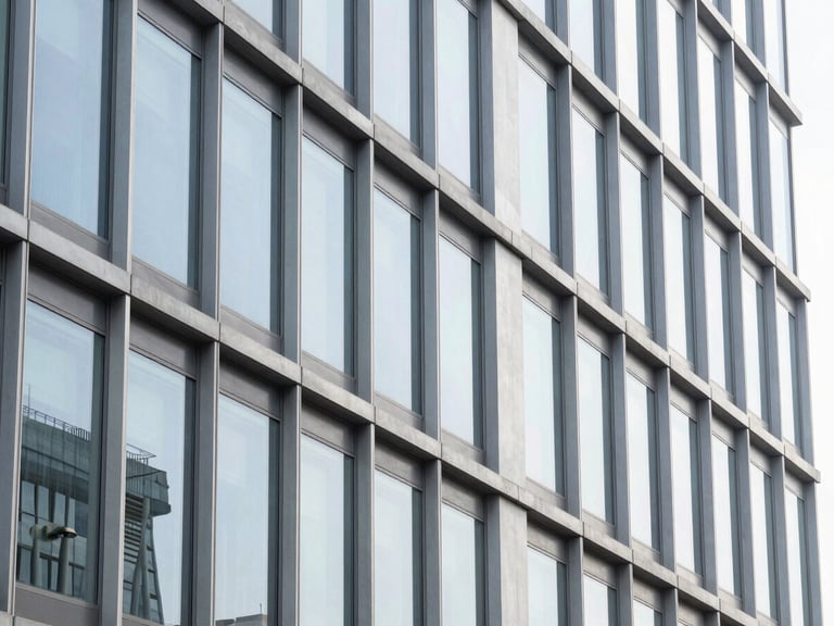 crisp corporate photography, abstract architectural details of a modern steel and glass building, bright natural lighting, ample negative space, high resolution, 35mm