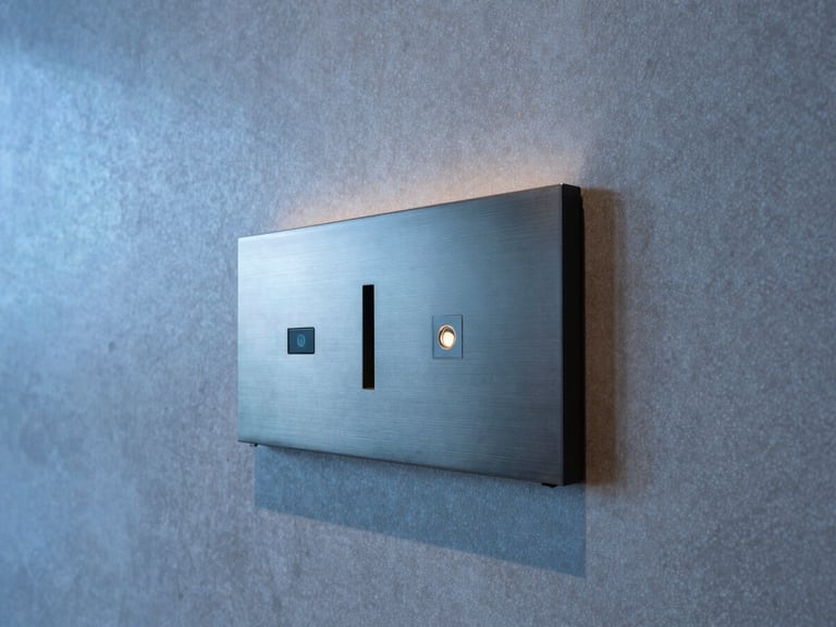 Detail shot of an architectural-grade access panel seamlessly integrated into a modern hotel lobby wall, cool-toned lighting, high-contrast, no people.