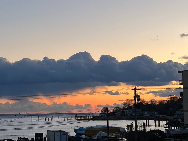 Photo of a serene sunset over Black Rock Harbor on Long Island Sound where Robert Ellis now lives. 