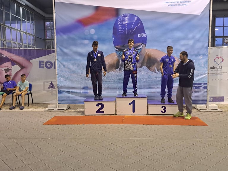a man standing on a podium with a medal