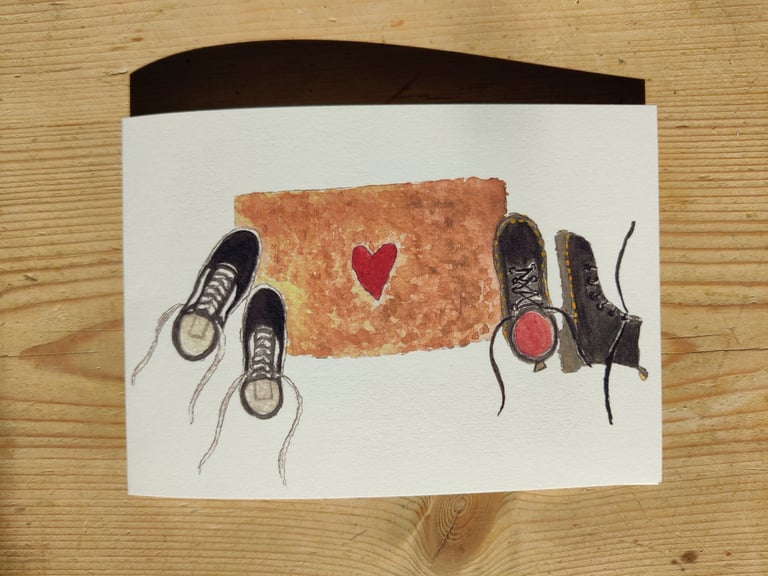 a queer romantic greetings card of a doormat with vans and doc martens