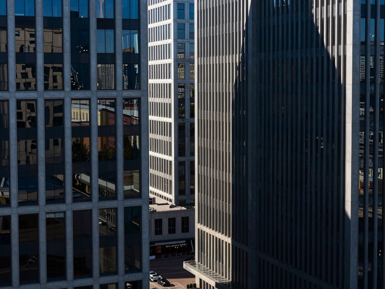 High-angle architectural view of modern corporate office buildings in St. Petersburg, sharp shadows, cool high-contrast daylight, deep blue tones