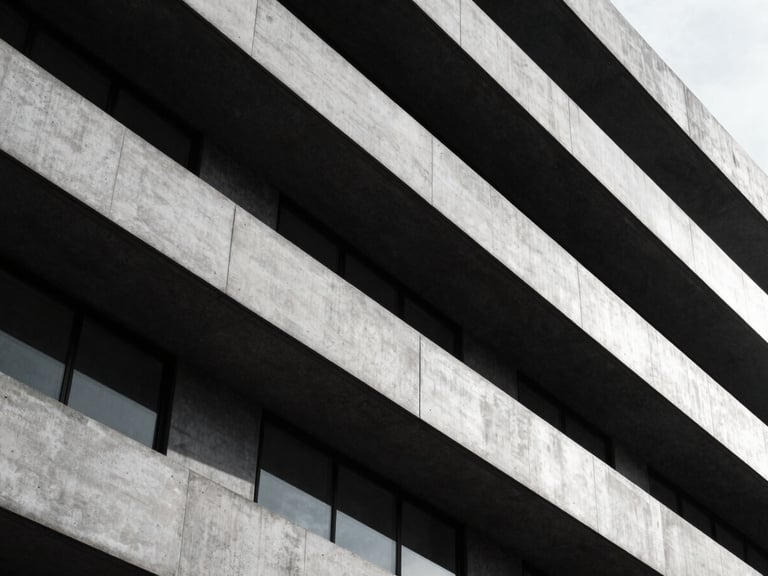 Abstract architectural geometry of a modern banking headquarters, sharp directional light, concrete and steel, high-contrast.