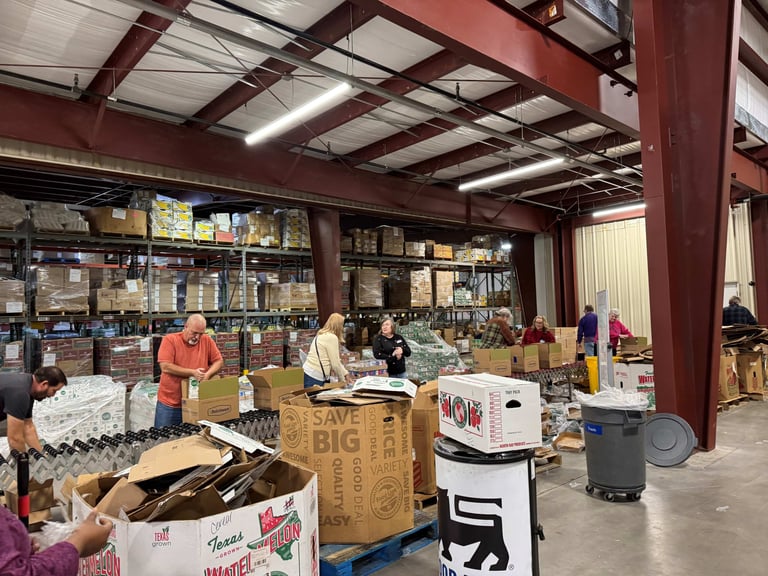 People working on a line at a food distribution center