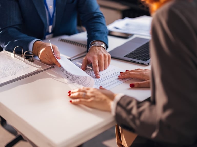 lawyer pointing to document for client