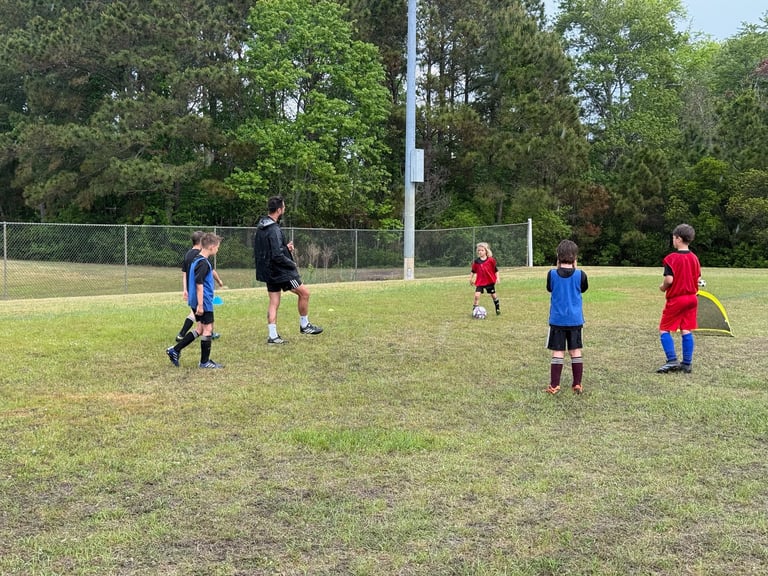 <img src="your-image-path.jpg" alt="Crestline FC coach leading a small-group soccer session with you