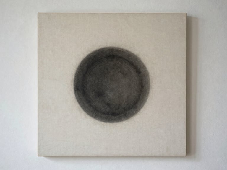 A straight-on, clean fine art photograph of a mixed media artwork on raw linen, featuring a single dark charcoal circle casting a subtle shadow.