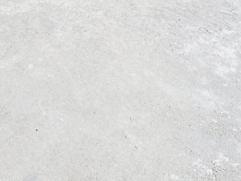 Close-up of a concrete surface treated with a construction chemical, showing enhanced durability and water resistance. Crisp natural daylight, sharp focus on the treated texture, minimalist composition, 35mm.