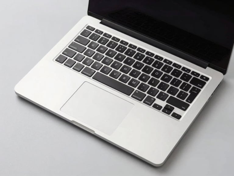 Top-down view of a sleek, modern laptop open on a clean desk, natural light, crisp studio lighting, light gray background, sharp details