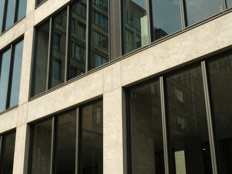 Abstract architectural detail of a modern concrete and glass financial headquarters in Zurich, sharp angles, warm afternoon side-lighting