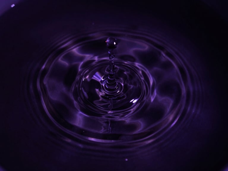 Macro photography of water ripples expanding outwards on a dark cosmic liquid surface, high-contrast chiaroscuro, deep violet tones, 35mm lens