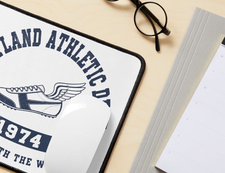 Retro 1974 athletic-style custom mouse pad on a desk with glasses.