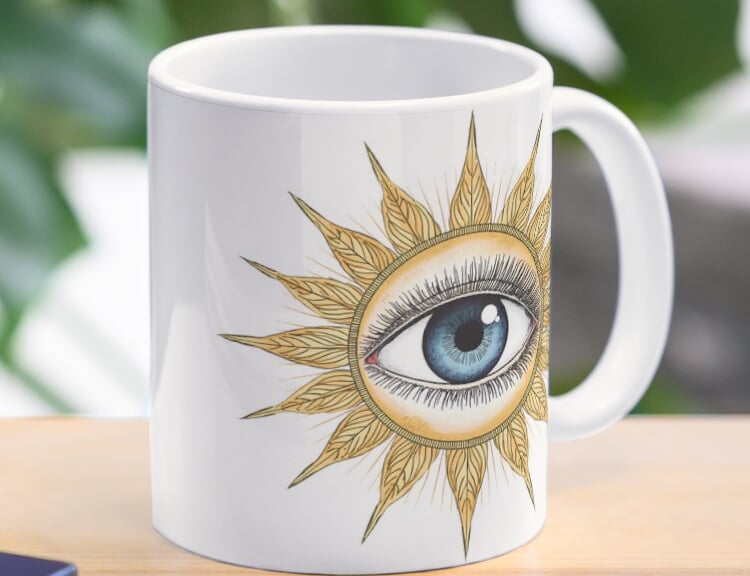 Ceramic mug featuring a vintage mystical sunburst eye design.