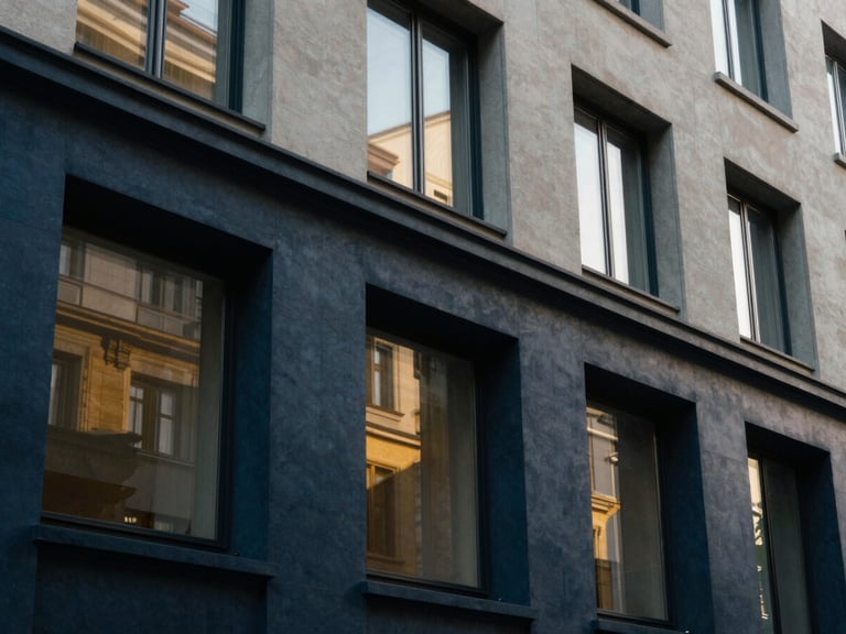 An elegant architectural close-up of a modern Swiss banking pavilion facade, clean lines, soft natural window light, deep navy shadows and warm gold reflections, 35mm