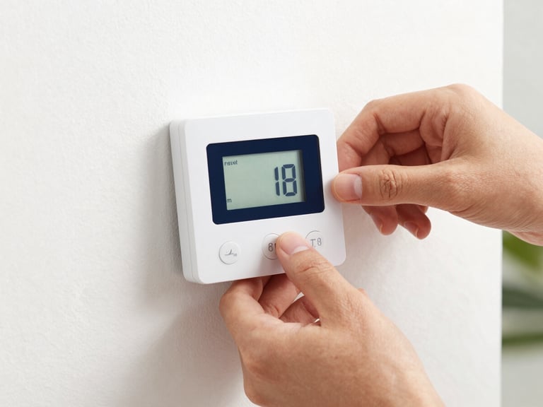 Close-up of clean hands adjusting a sleek modern thermostat in a well-lit upscale home, high contrast, crisp commercial photography.