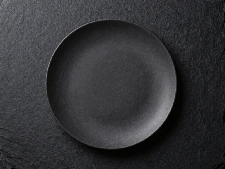 Minimalist high-end culinary plating mockup on a dark slate background, professional studio lighting, focus on texture and composition