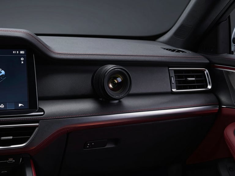 Close-up of a luxury car interior, stitched leather dashboard, modern infotainment screen, soft ambient lighting, 35mm prime lens