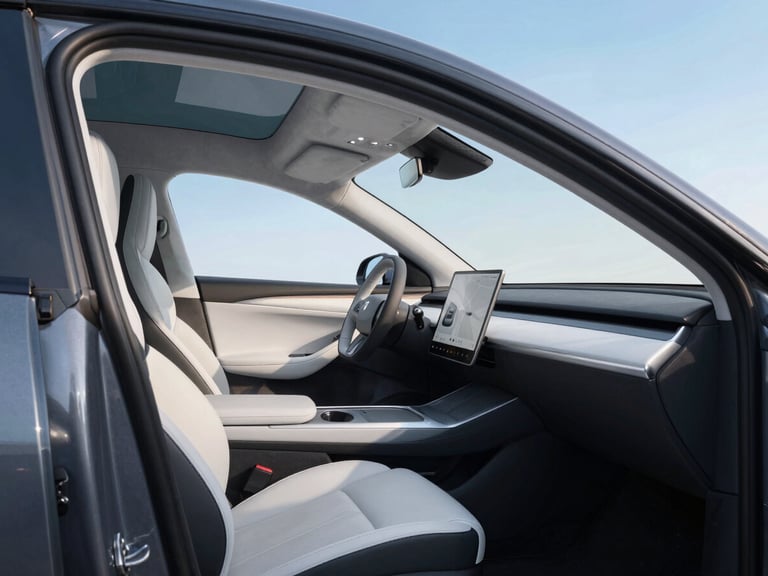 Luxurious electric SUV taxi, dark grey, interior shot showing comfortable seating and modern dashboard, bright studio light, medium detail.