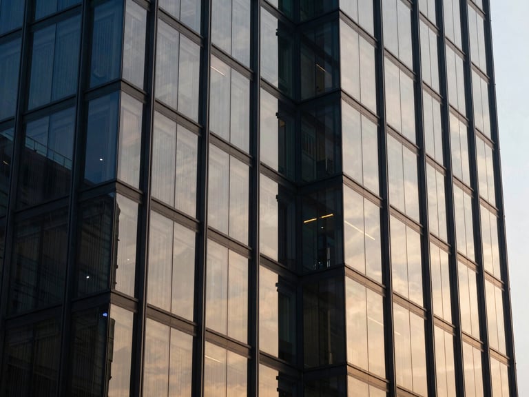 Close-up of architectural glass reflections on a modern high-tech office building in Jakarta, cool morning light, deep navy and gold tones