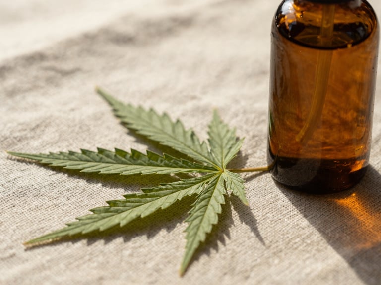 Macro shot of organic hemp texture and a dark amber glass bottle on raw linen fabric, soft natural sunlight, warm tones, 35mm