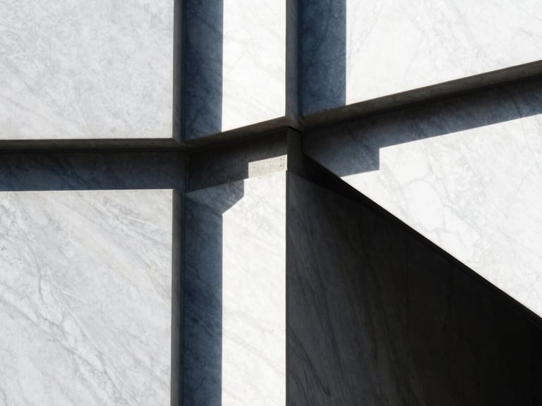 Tight abstract detail of premium white marble and dark concrete joints, sharp architectural shadows, high-contrast sunlight, editorial style