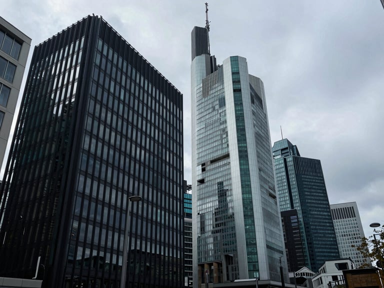 Wide panoramic architectural shot of a modern financial center facade in Frankfurt, sharp geometric shadows, overcast daylight, deep navy and teal tones, 35mm