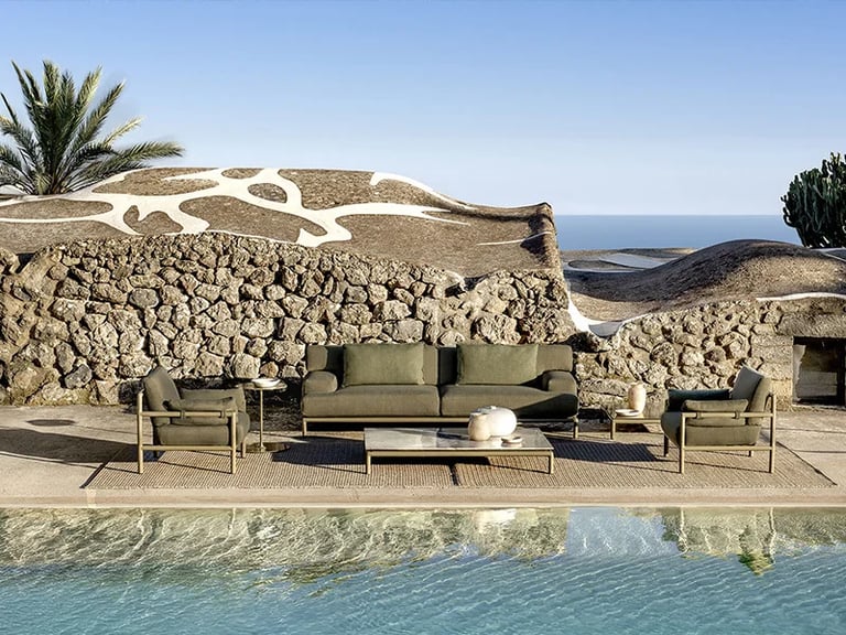 Elegant outdoor lounge area with durable seating materials, stone textures, woven details and soft c