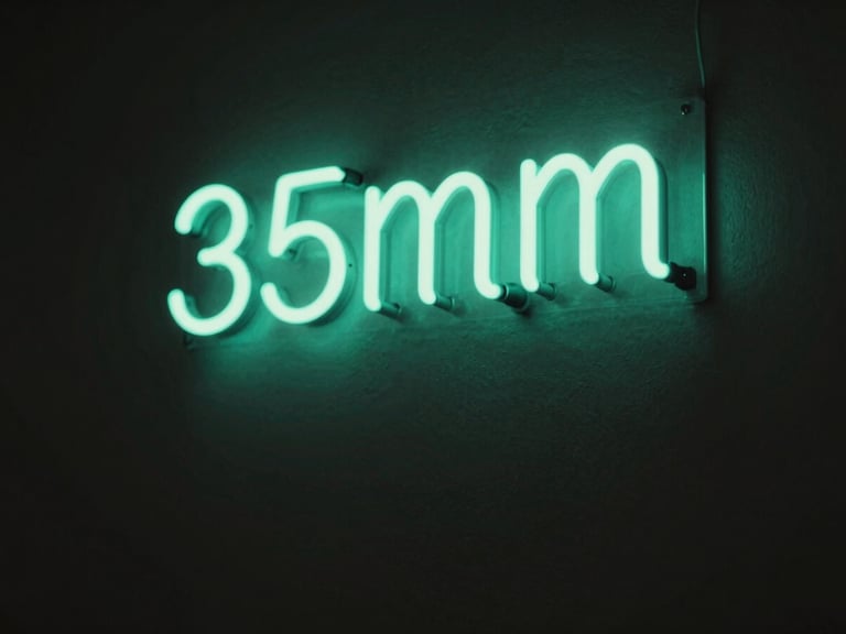 Low-key dramatic photo of a glowing sea-green neon sign on a dark charcoal wall, soft ambient light, shallow depth of field, 35mm