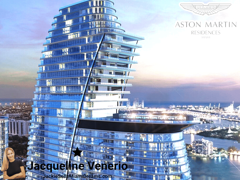 A luxury skyscraper with curved glass facade and the Aston Martin logo on top, located in Miami, Fl