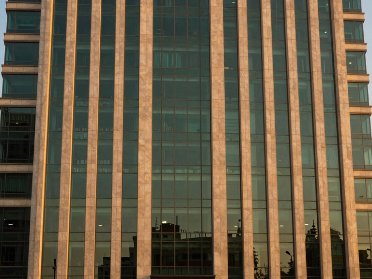 Modern commercial glass skyscraper facade in Islamabad at dusk, warm golden light reflecting off premium materials, clean symmetrical composition, 35mm