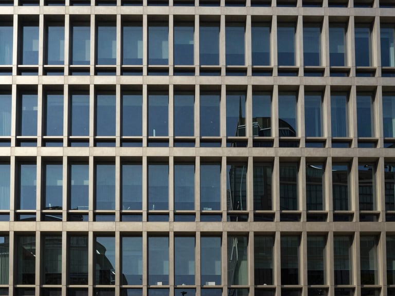 Architectural shot of a modern office building facade, clean lines, geometric symmetry, bright natural daylight, deep navy tones, 35mm