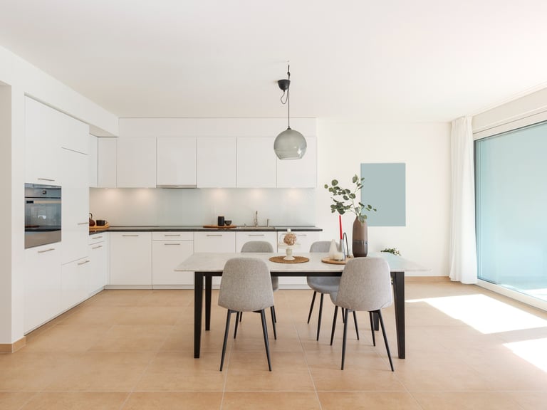 a dining room with a table and chairs