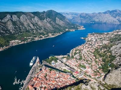 Aerial view of UNESCO World Heritage Kotor Old Town in Montenegro with cruise ship moored