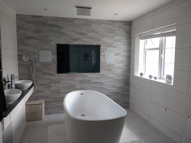 Professional installation of a flush-mounted waterproof bathroom TV in a luxury London