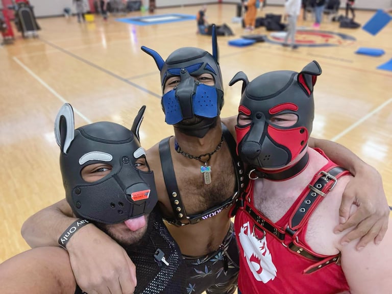 Three men in a gymnasium posing pup masks.